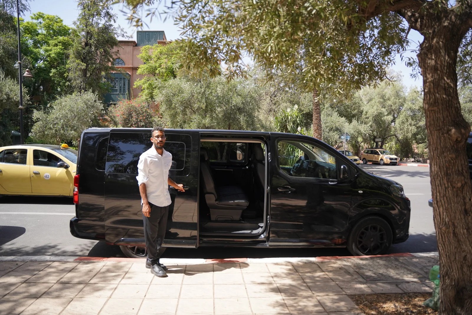 RANA driver beside a private tour vehicle